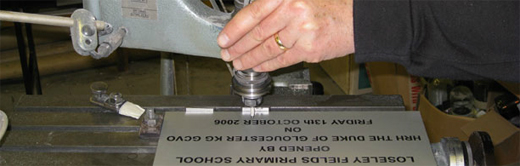 A close-up of one of our engravers working on an engraved plaque